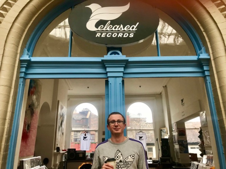 A landscape picture of Liam McIntyre outside his independent record store